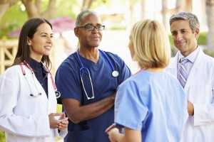 Image of a medical team having a discussion outdoors.