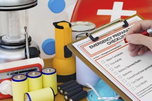 Image of someone putting together an emergency kit using a check list.